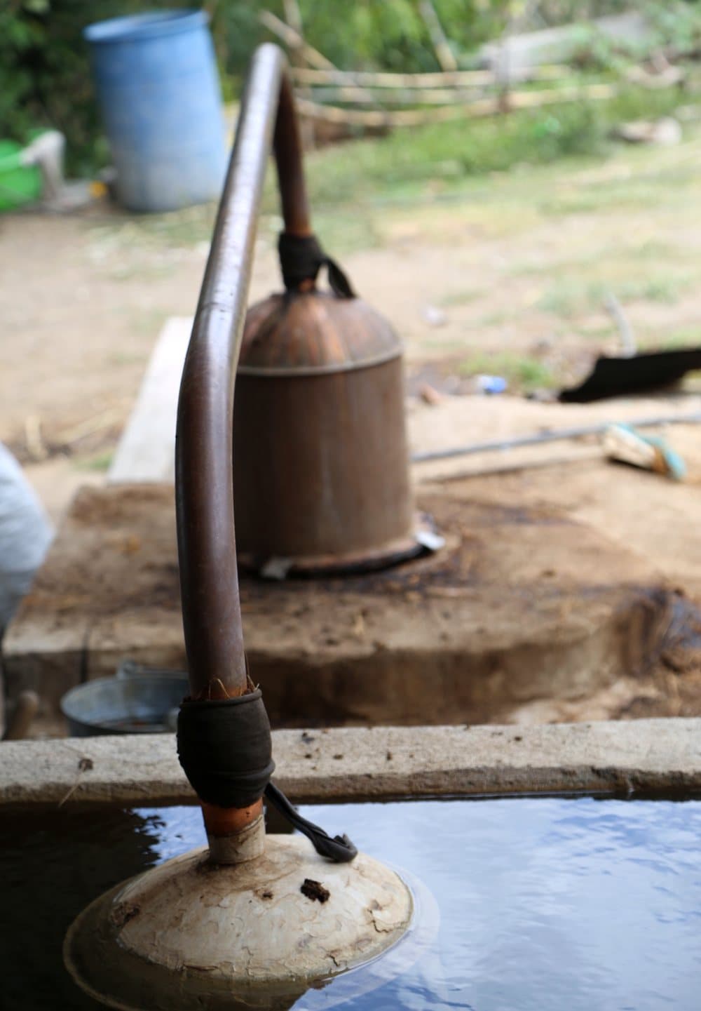 A copper arm running from the still into a tank of water