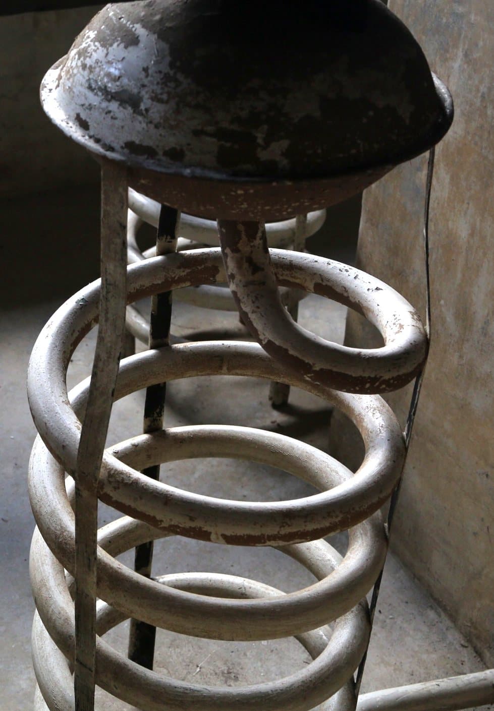 A metal condenser coil inside a water tank
